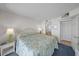 Bedroom features a comfortable bed, wicker furniture, and access to the bathroom at 523 S Ocean Blvd. # 305, North Myrtle Beach, SC 29582