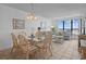 Cozy dining area with a glass table, seating for six, and living room view at 523 S Ocean Blvd. # 305, North Myrtle Beach, SC 29582