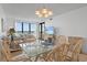 Dining area featuring a glass-top table, seating for six, and an ocean view at 523 S Ocean Blvd. # 305, North Myrtle Beach, SC 29582