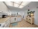 Bright kitchen with white appliances, tile floors, and bar seating with a view into the dining room at 523 S Ocean Blvd. # 305, North Myrtle Beach, SC 29582