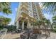 Outdoor patio with barbecue, picnic tables, and fire pit for residents at 523 S Ocean Blvd. # 305, North Myrtle Beach, SC 29582