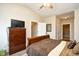 Bedroom boasts wooden floors, dresser with tv, and ensuite bathroom access at 5650 Barefoot Resort Bridge Rd. # 431, North Myrtle Beach, SC 29582