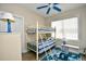 Charming bedroom featuring a bunk bed, ceiling fan, and vibrant seahorse-themed rug at 5650 Barefoot Resort Bridge Rd. # 431, North Myrtle Beach, SC 29582