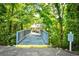 Picturesque wooden bridge leading to the pool area, surrounded by lush greenery at 5650 Barefoot Resort Bridge Rd. # 431, North Myrtle Beach, SC 29582