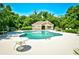 Inviting community pool surrounded by lounge chairs and lush landscaping, ideal for relaxation at 5650 Barefoot Resort Bridge Rd. # 431, North Myrtle Beach, SC 29582