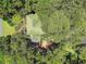 Aerial shot showcasing a beautiful home with mature trees, lush landscaping, and a brick pathway at 571 Fernwood Rd., Murrells Inlet, SC 29576