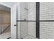 Updated shower with white subway tile and contrasting black accents at 571 Fernwood Rd., Murrells Inlet, SC 29576