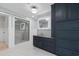 Beautiful bathroom featuring a glass shower, marbled floors and countertops, and blue cabinets at 571 Fernwood Rd., Murrells Inlet, SC 29576