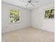 Clean, bright bedroom with neutral carpet and natural light from two windows at 571 Fernwood Rd., Murrells Inlet, SC 29576
