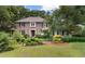 Charming brick home featuring mature landscaping, a manicured lawn, and a welcoming front entrance at 571 Fernwood Rd., Murrells Inlet, SC 29576