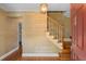 Inviting foyer featuring hardwood floors, a wooden staircase, and decorative wall coverings at 571 Fernwood Rd., Murrells Inlet, SC 29576