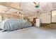 Spacious garage with covered car, storage shelves, and access door at 571 Fernwood Rd., Murrells Inlet, SC 29576