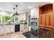 Modern kitchen with custom cabinets, black appliances, and stainless steel double ovens at 571 Fernwood Rd., Murrells Inlet, SC 29576