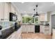 Well-lit kitchen boasting black countertops, custom cabinets, and a large window overlooking the backyard at 571 Fernwood Rd., Murrells Inlet, SC 29576