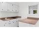 Kitchenette with white cabinets, granite countertops, and a built-in cooktop at 571 Fernwood Rd., Murrells Inlet, SC 29576