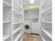 Laundry room with washer, dryer, and built-in shelving for storage at 571 Fernwood Rd., Murrells Inlet, SC 29576