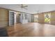 Bright living room featuring hardwood floors, custom built-in shelving, and large windows at 571 Fernwood Rd., Murrells Inlet, SC 29576