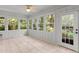 Sunroom featuring multiple windows and a door showing the outside yard at 571 Fernwood Rd., Murrells Inlet, SC 29576