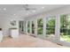 Light-filled sunroom features many windows and glass doors to the outside patio at 571 Fernwood Rd., Murrells Inlet, SC 29576