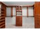 Spacious walk-in closet features wooden built-ins and ample hanging storage at 571 Fernwood Rd., Murrells Inlet, SC 29576