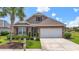 Charming single Gathering home featuring a well-manicured lawn, stone accents, and an attached two car garage at 5716 Lombardia Circle, Myrtle Beach, SC 29579