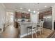 Bright open kitchen with granite countertops, center island with seating, and stainless steel appliances at 5716 Lombardia Circle, Myrtle Beach, SC 29579