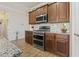 Modern kitchen featuring wood cabinets, stainless steel appliances, and granite countertops with backsplash at 5716 Lombardia Circle, Myrtle Beach, SC 29579