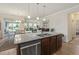 Spacious kitchen with granite countertops, stainless steel appliances, and an open view to the living and dining areas at 5716 Lombardia Circle, Myrtle Beach, SC 29579