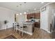 Bright kitchen with wood cabinets, granite countertops, stainless steel appliances and an island with seating at 5716 Lombardia Circle, Myrtle Beach, SC 29579