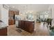 Spacious open-concept kitchen featuring an island, stainless steel appliances, and dark wood cabinets at 5716 Lombardia Circle, Myrtle Beach, SC 29579