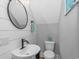 Charming powder room with shiplap walls, a modern round mirror, and sleek fixtures at 6001 - 1195 S Kings Hwy., Myrtle Beach, SC 29575