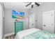 Comfortable bedroom featuring a teal dresser, beachy decor, and a mounted TV at 6001 - 1195 S Kings Hwy., Myrtle Beach, SC 29575