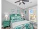 Cozy bedroom featuring a teal bed, matching nightstands, and coastal-themed decor at 6001 - 1195 S Kings Hwy., Myrtle Beach, SC 29575