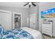 Beach-themed bedroom features a blue seashell comforter, shiplap accent wall, and an ensuite bathroom for added convenience at 6001 - 1195 S Kings Hwy., Myrtle Beach, SC 29575