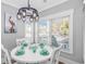 Bright dining area featuring a round table, stylish chandelier, and picturesque window views at 6001 - 1195 S Kings Hwy., Myrtle Beach, SC 29575
