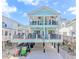 Beautiful two-story home with balconies, outdoor seating, and golf cart parking underneath at 6001 - 1195 S Kings Hwy., Myrtle Beach, SC 29575