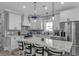 Spacious kitchen with white cabinets, stainless steel appliances, and a large marble countertop island with seating at 6001 - 1195 S Kings Hwy., Myrtle Beach, SC 29575