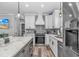 Modern kitchen featuring white cabinets, stainless steel appliances, and a center island with marble countertops at 6001 - 1195 S Kings Hwy., Myrtle Beach, SC 29575