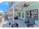 Spacious porch with ceiling fans, outdoor seating, and a picnic table at 6001 - 1195 S Kings Hwy., Myrtle Beach, SC 29575