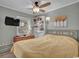Bright bedroom with a full bed, ceiling fan, bookcase, and natural light at 6001 - 1459 S Kings Hwy., Myrtle Beach, SC 29575