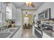 Bright kitchen with stainless steel appliances, light wood flooring, and white cabinets at 6001 - 1459 S Kings Hwy., Myrtle Beach, SC 29575