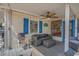 Comfortable covered porch featuring a stylish sofa, ceiling fan, and pleasant outdoor living space at 6001 - 1459 S Kings Hwy., Myrtle Beach, SC 29575