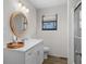 Bright bathroom with a round mirror, modern sink and vanity, plus a glass-enclosed shower at 6001 - Z-49 S Kings Hwy., Myrtle Beach, SC 29575