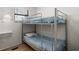 Small bedroom featuring sturdy bunk beds, a built-in shelf, and a window at 6001 - Z-49 S Kings Hwy., Myrtle Beach, SC 29575