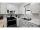 Bright kitchen features white cabinetry, stainless appliances, and plenty of counter space at 6001 - Z-49 S Kings Hwy., Myrtle Beach, SC 29575