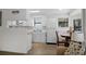 Bright kitchen features white cabinetry, modern appliances, and dining area at 6001 - Z-49 S Kings Hwy., Myrtle Beach, SC 29575