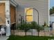 Cozy backyard featuring a metal garden arch, decorative plants, and well-maintained landscaping at 651 Choctaw Dr., Conway, SC 29526