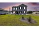 Charming two-story home with gray siding, black shutters and manicured front yard at 651 Choctaw Dr., Conway, SC 29526