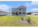 Charming two-story home with gray siding, black shutters and manicured front yard at 651 Choctaw Dr., Conway, SC 29526