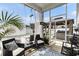 Inviting porch with stylish wicker seating, a glass table, and open views of the outdoor pergola and hot tub at 651 Choctaw Dr., Conway, SC 29526